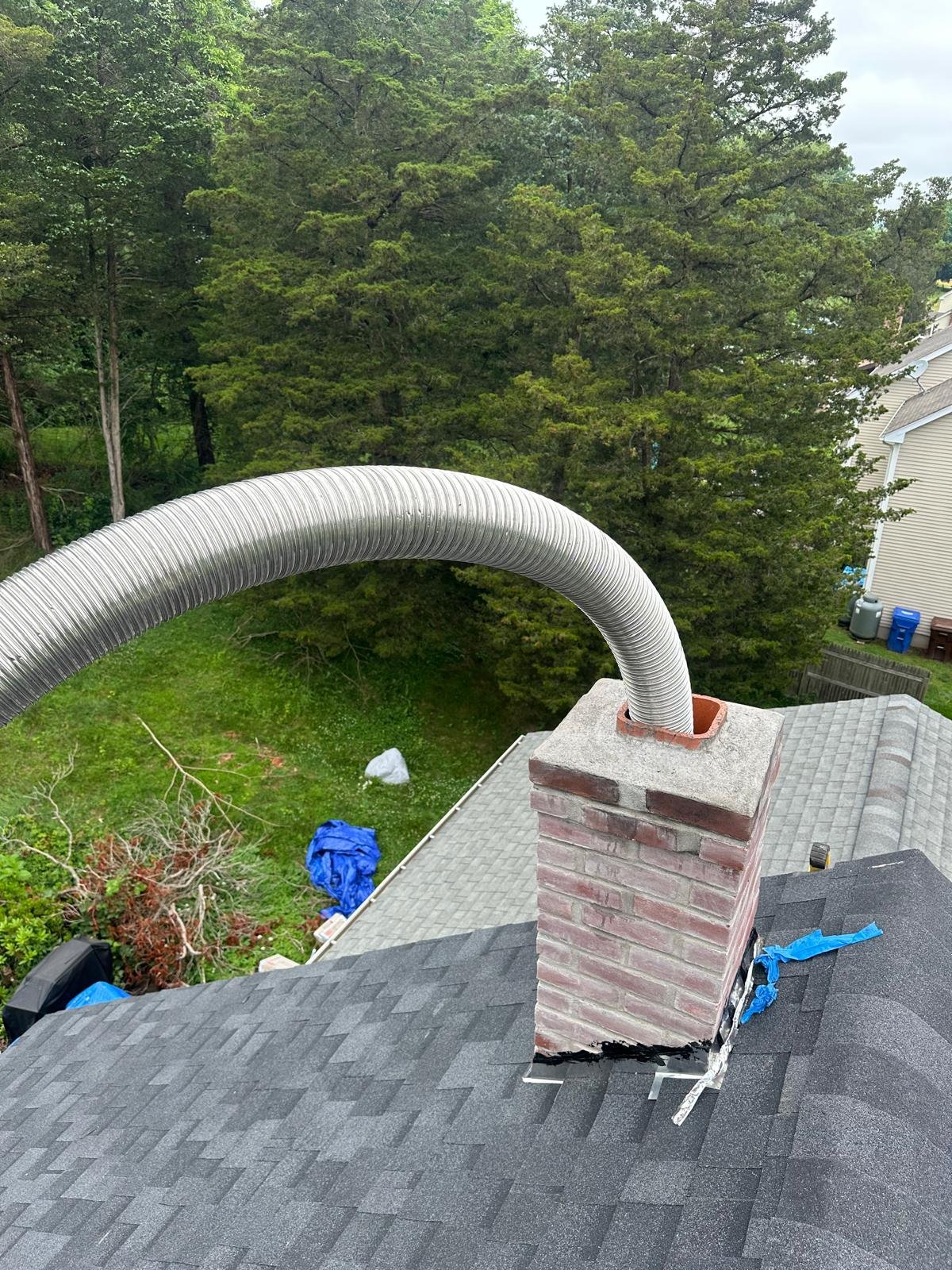 Stainless steel chimney liner being lowered into a Connecticut chimney — Chimneys Empire